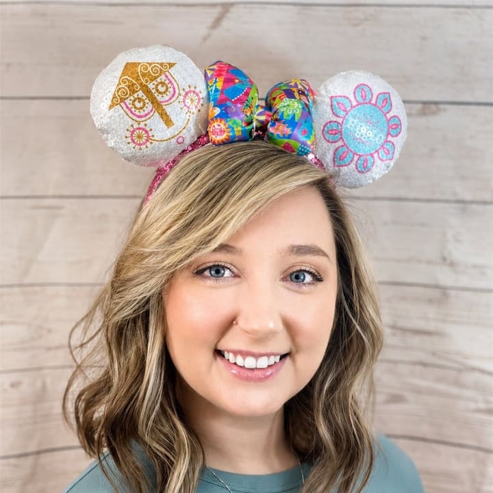Cass smiling in a pair of sparkly mouse-ear headbands